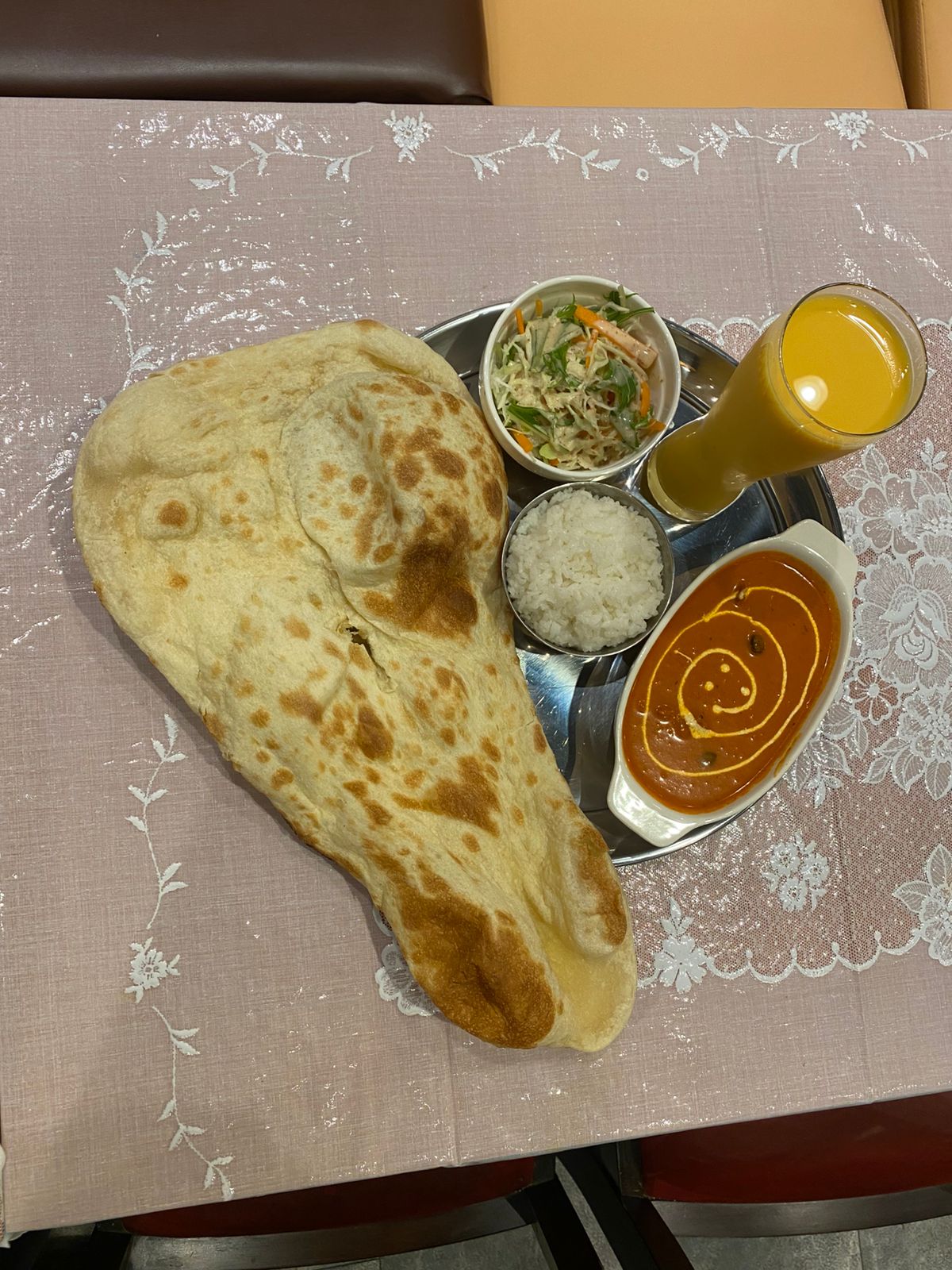 Lunch set with naan, curry, rice, salad, and drink